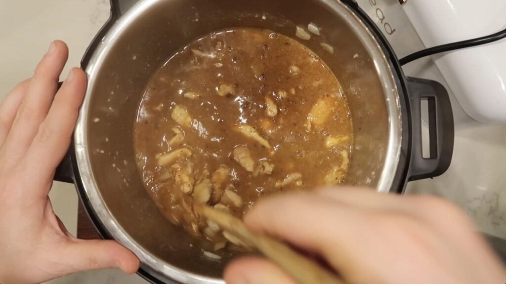 Stirring the spices into the broth